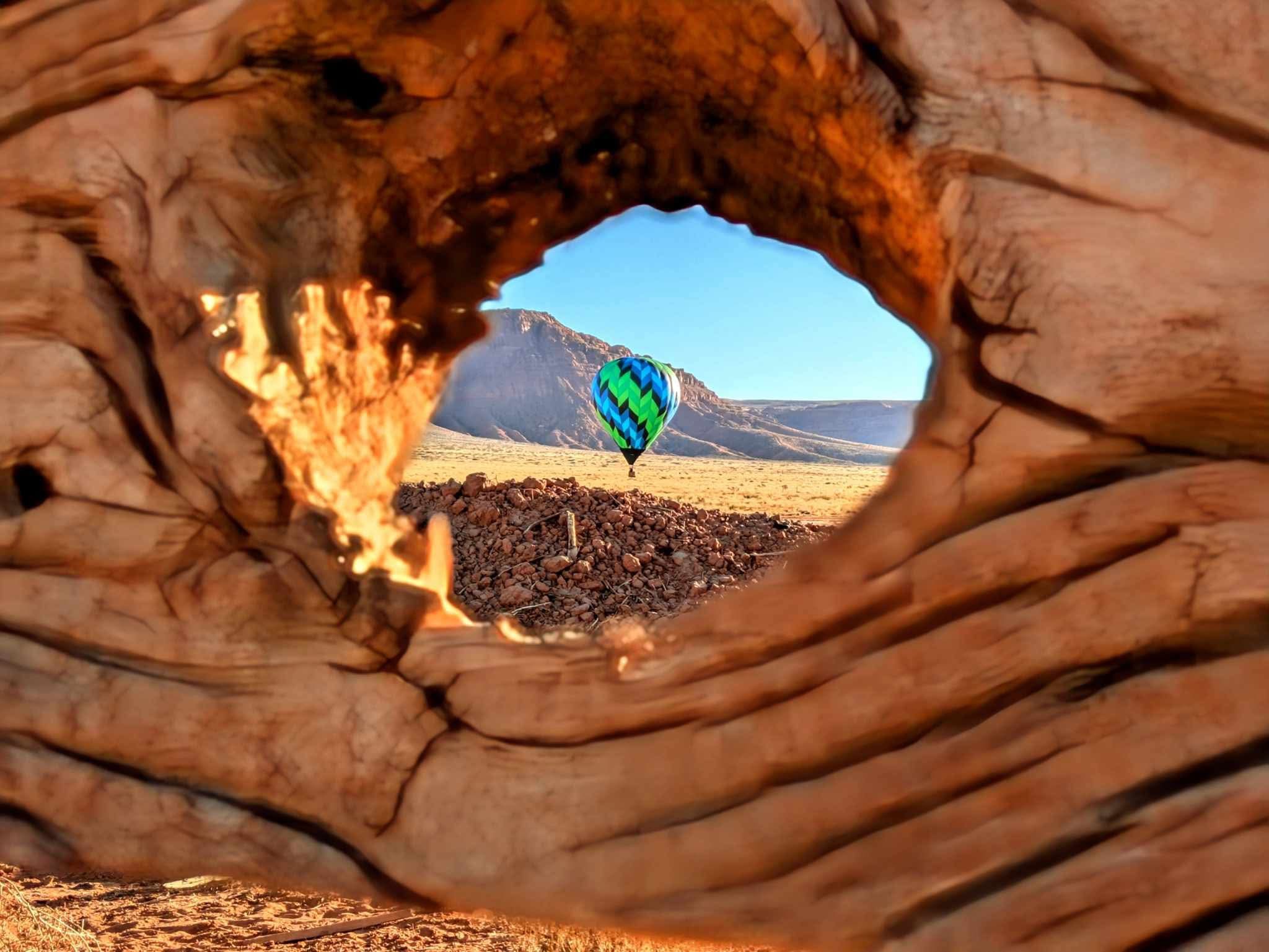Balloon viewed through wooden fence.